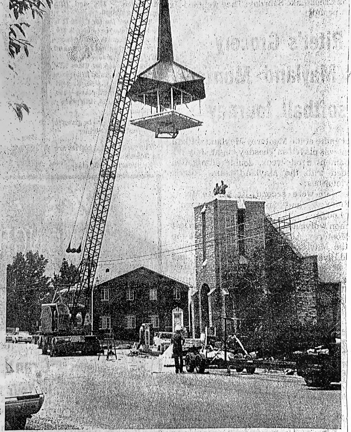 The new steeple being raised atop the tower