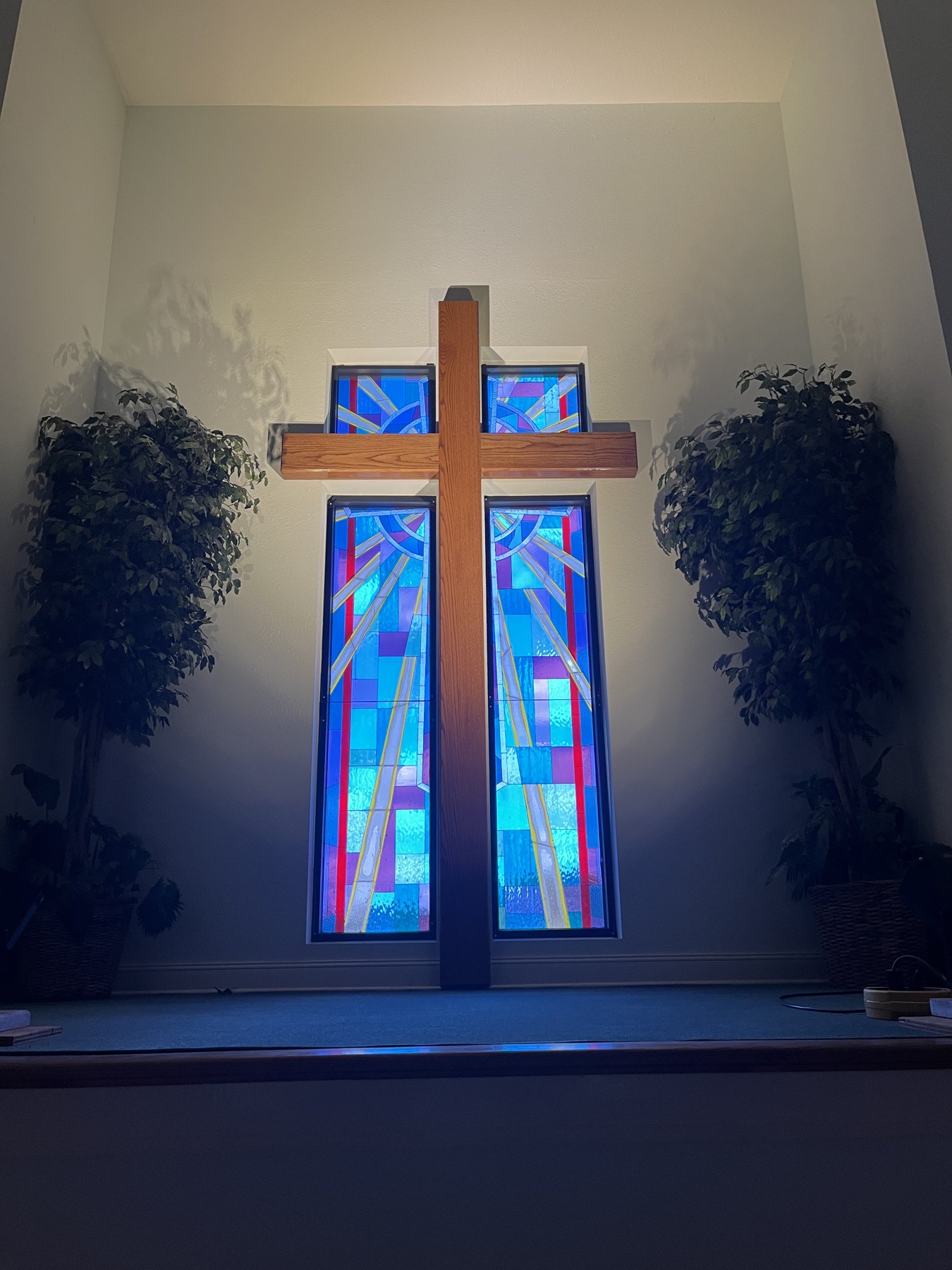 The cross and stained glass in the sanctuary